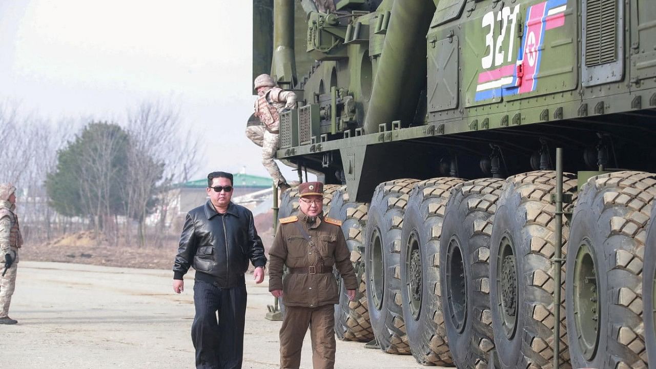 North Korean leader Kim Jong Un walks next to what state media reports is the "Hwasong-17" intercontinental ballistic missile (ICBM) on its launch vehicle. Credit: Reuters Photo