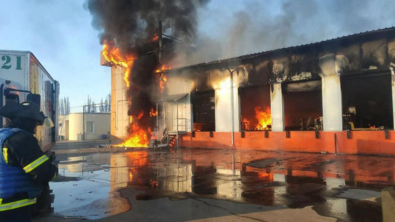 This handout picture taken and released by Ukrainian State Emergency Service Press Service on March 21, 2022 shows firefighters putting out a large-scale fire at a food warehouse in Severodonetsk, Lugansk region, destroyed following Russian shelling. Credit: AFP Photo/Ukrainian State Emergency Service Press Service