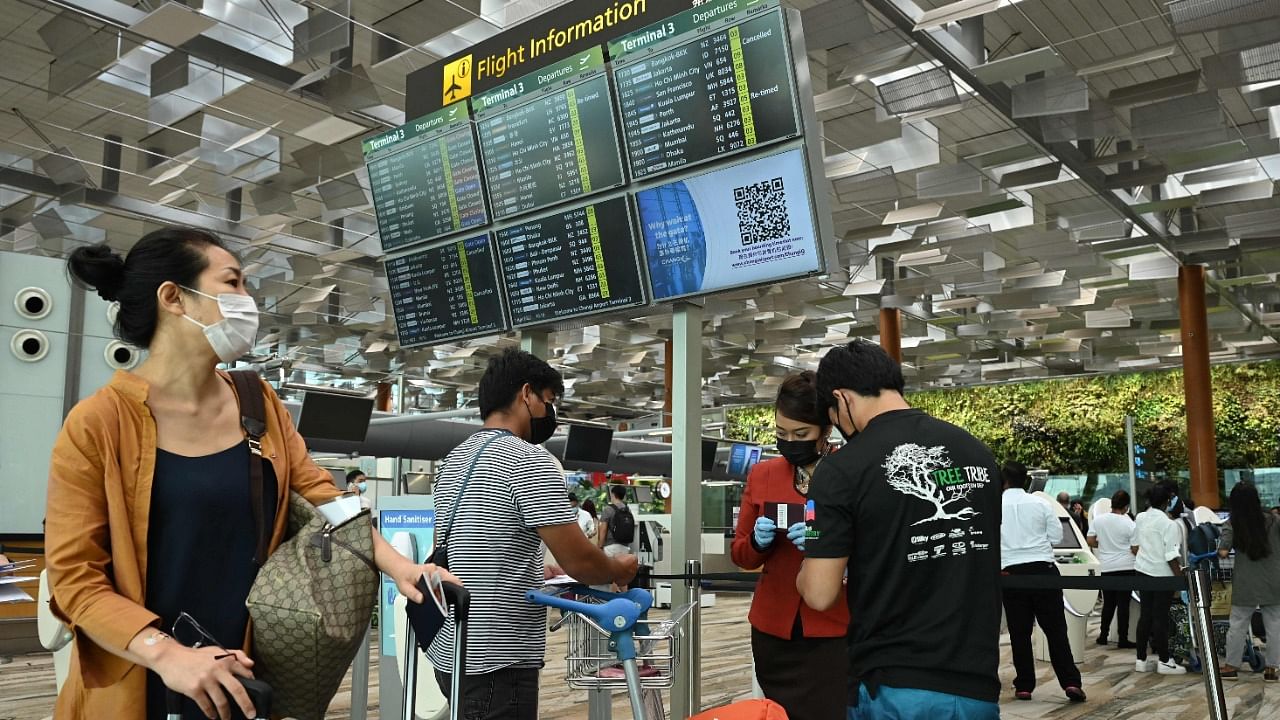Passengers arrive at the Singapore airport. Credit: AFP Photo