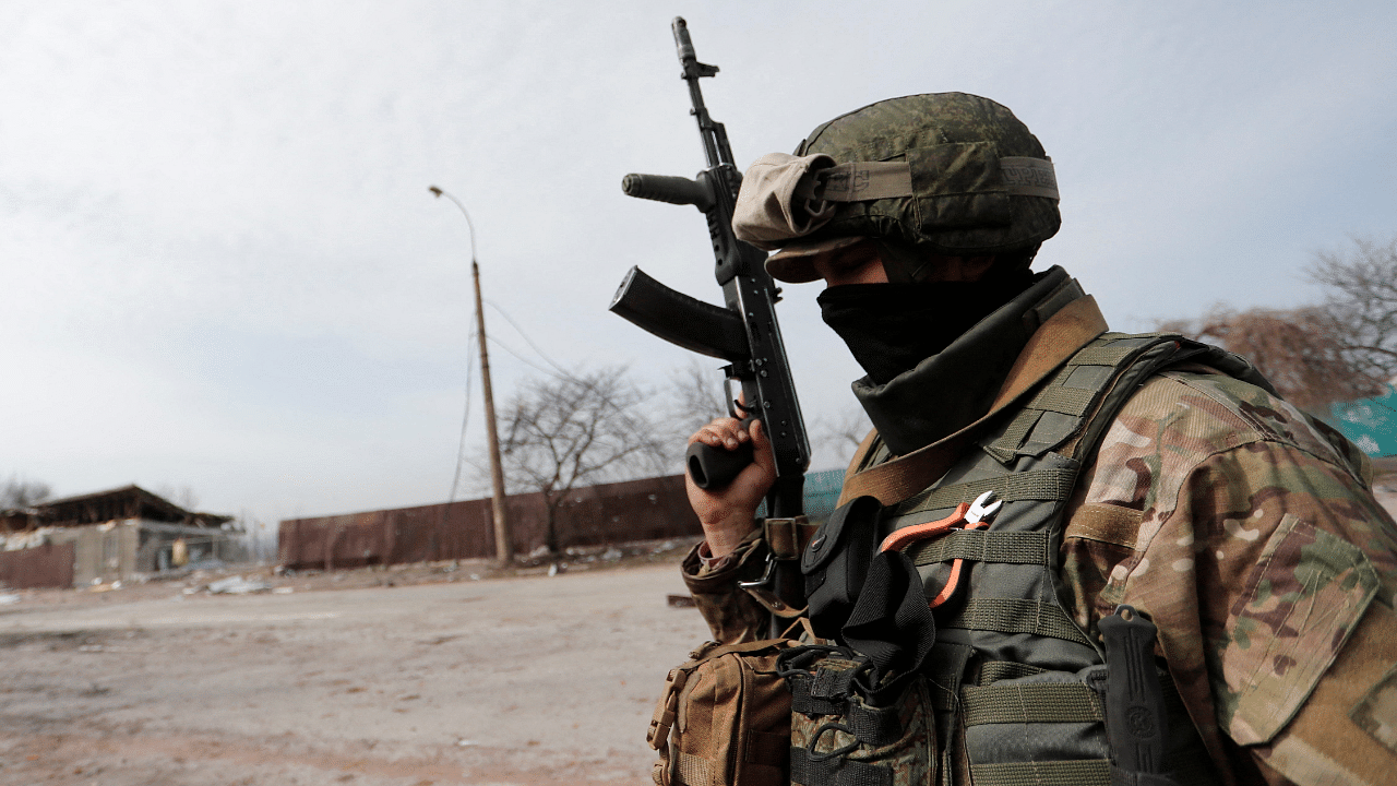 A service member of pro-Russian troops stands in a street in Mariupol. Credit: Reuters Photo