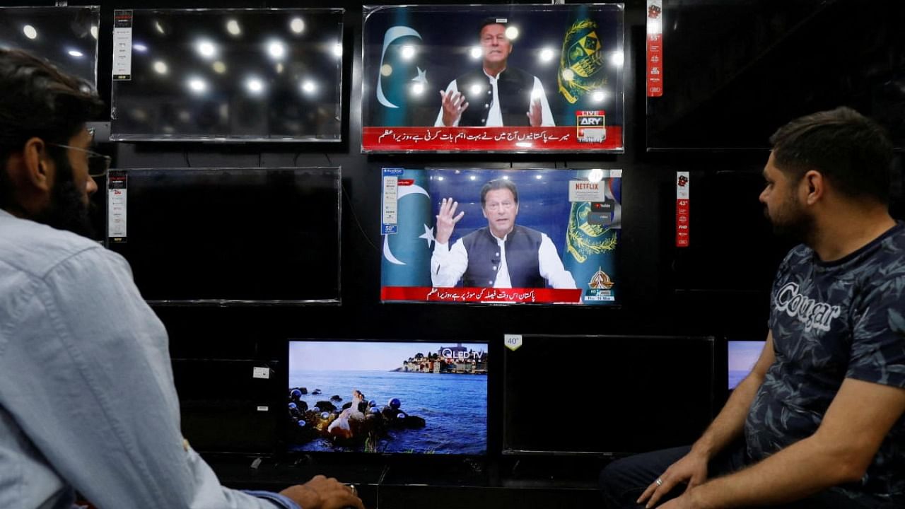 People watch the speech of Pakistani Prime Minister Imran Khan on television screens, in Islamabad. Credit: Reuters photo