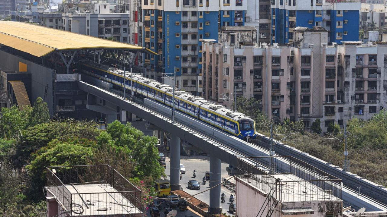A metro train runs on its track during preparations for the inauguration of Mumbai Metro's 2A line, at Borivali in Mumbai. Credit: PTI Photo