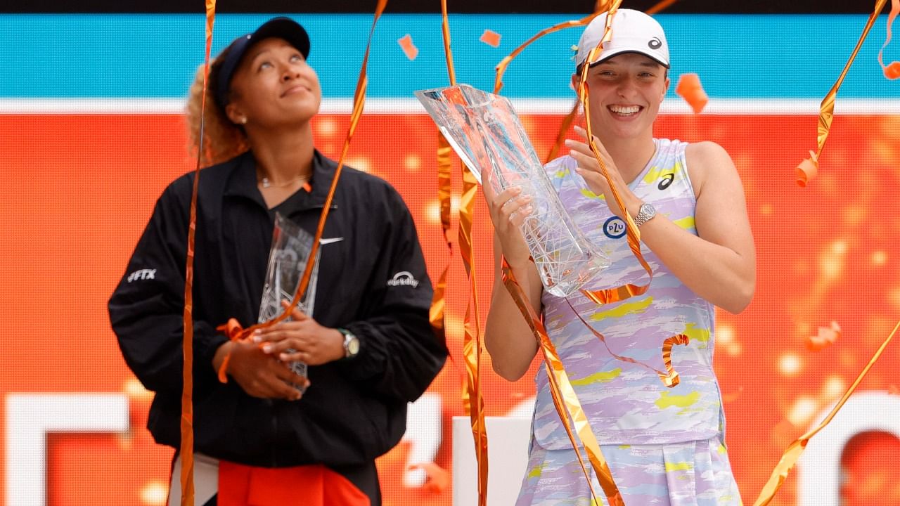 ga Swiatek (POL)(R) holds the Butch Buchholz Championship Trophy as Naomi Osaka (JPN)(L) holds the finalists' trophy during the awards ceremony after their women's singles final in the Miami Open at Hard Rock Stadium. Credit: Geoff Burke-USA TODAY Sports