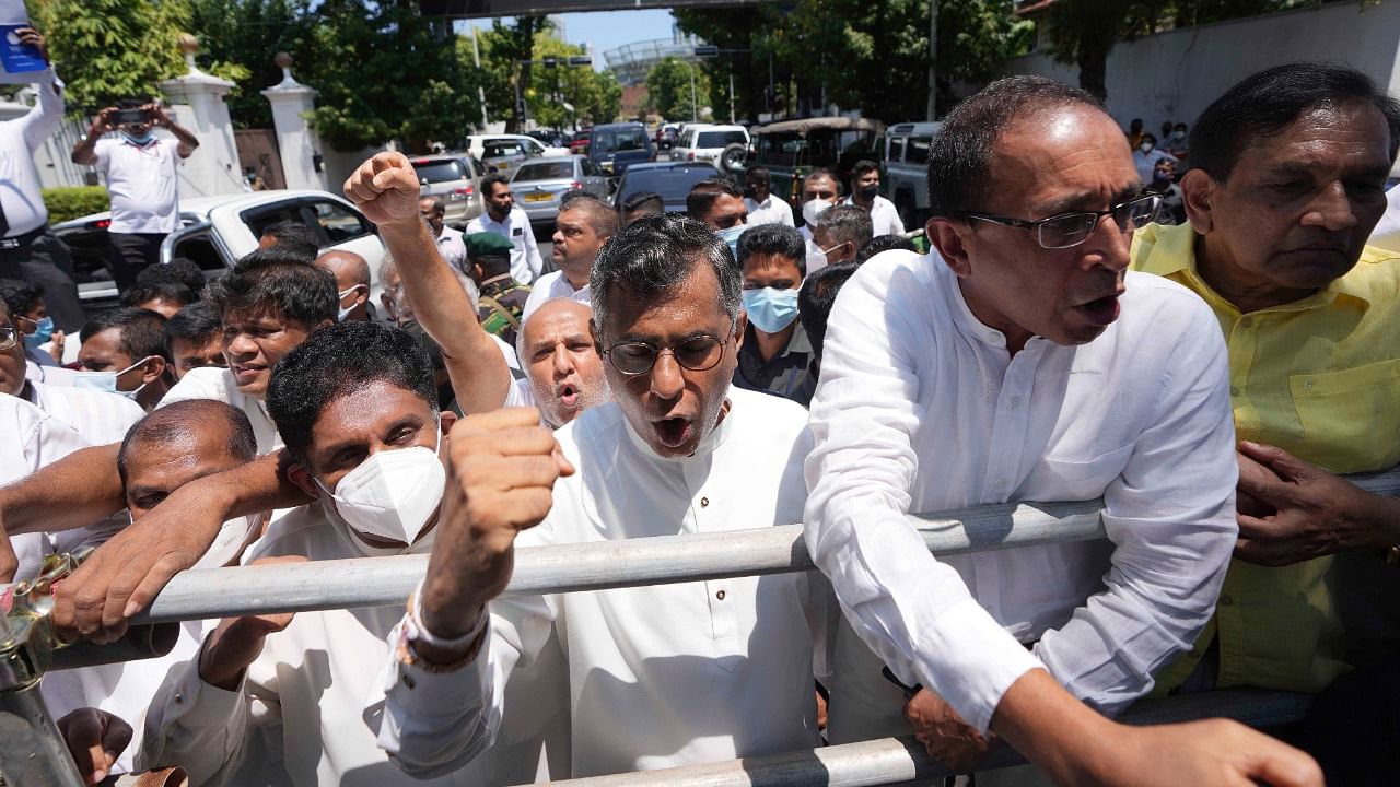 Sri Lankan opposition leader Sajith Premadasa, left, along with other opposition lawmakers shout anti government slogans during a protest in Colombo. Credit: AP/PTI Photo