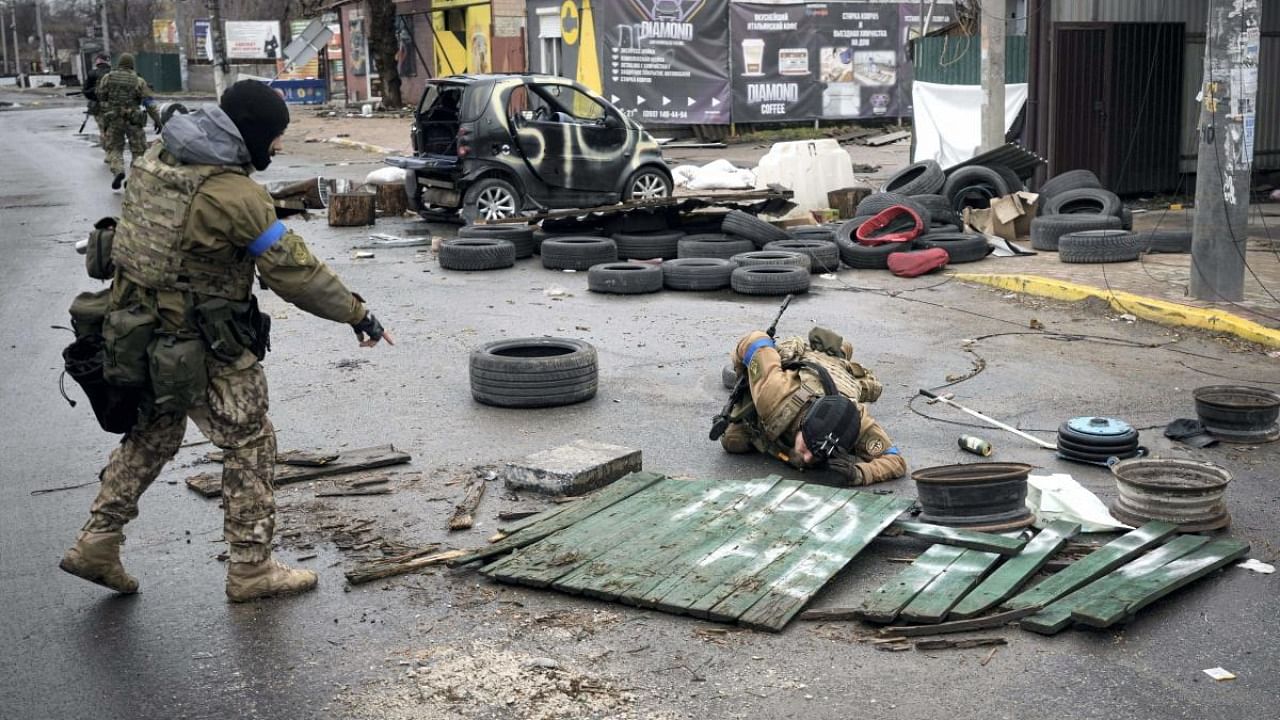 Ukrainian servicemen check streets for booby traps in the formerly Russian-occupied Kyiv suburb of Bucha. Credit: AP/PTI Photo