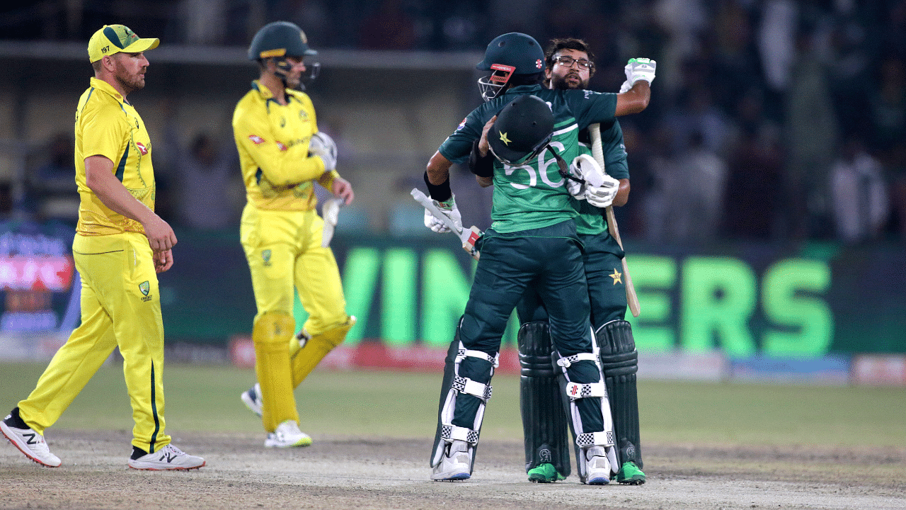 Pakistan's Babar Azam, second right, and Imam-ul-Haq congratulate each other after the winning third one day international cricket match against Australia at Gaddafi Stadium in Lahore. Credit: AP Photo