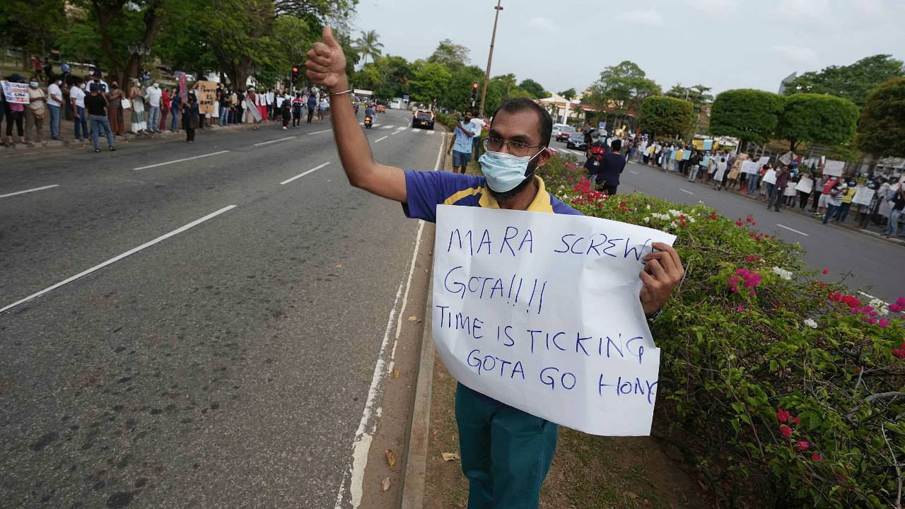 A Sri Lankan man protests against the economic crisis, before the beginning of curfew in Colombo, Sri Lanka. Credit: AP Photo