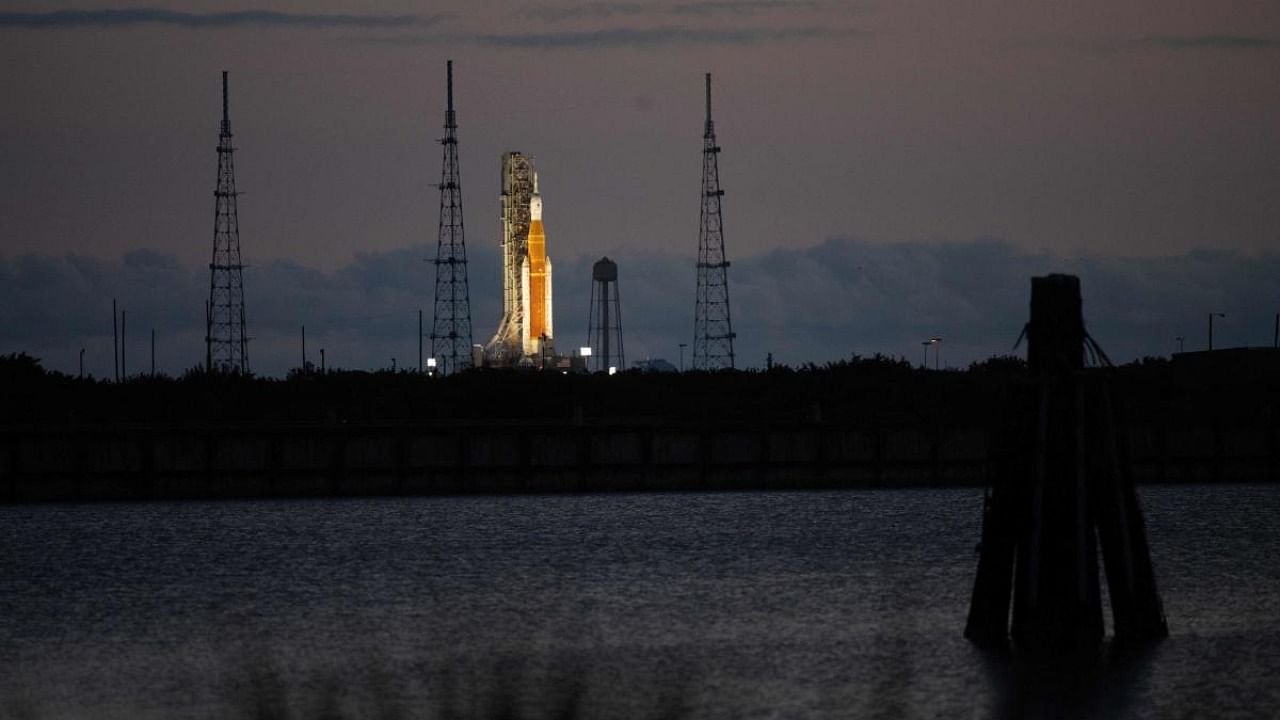 In this NASA handout photo, NASA’s Space Launch System (SLS) rocket with the Orion spacecraft aboard is seen at sunrise atop a mobile launcher at Launch Complex 39B, as the Artemis I launch team conducts the wet dress rehearsal test on April 3, 2022, at NASA’s Kennedy Space Center in Florida. Credit: AFP Photo