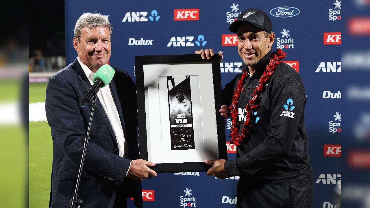 New Zealand Cricket Chairman Martin Snedden (L) poses with New Zealand’s Ross Taylor after Taylor's last match for New Zealand during the third one-day international (ODI) cricket match between New Zealand and Netherlands at Seddon Park in Hamilton on April 4, 2022. (Photo by Michael Bradley / AFP)
