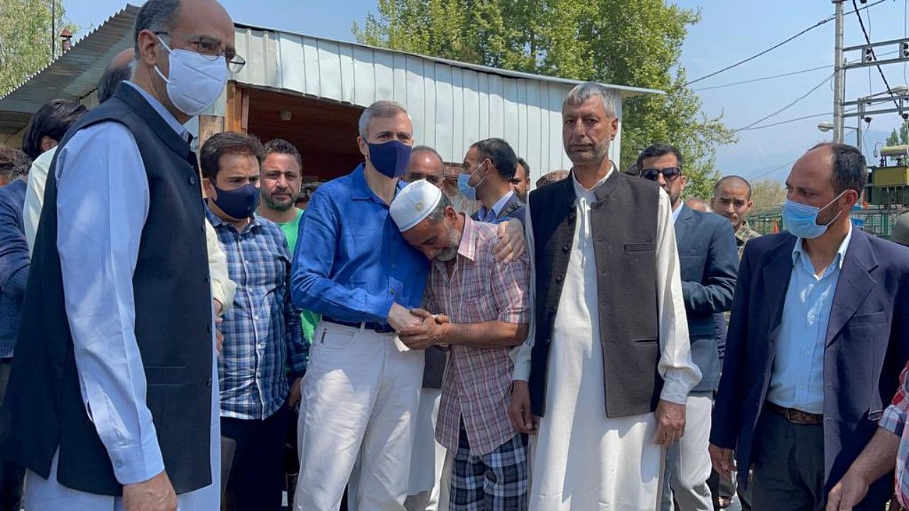 Omar Abdullah on Tuesday visited Nageen Lake to meet the owners of the houseboats which were gutted in a recent fire. Credit: Twitter/ @OmarAbdullah