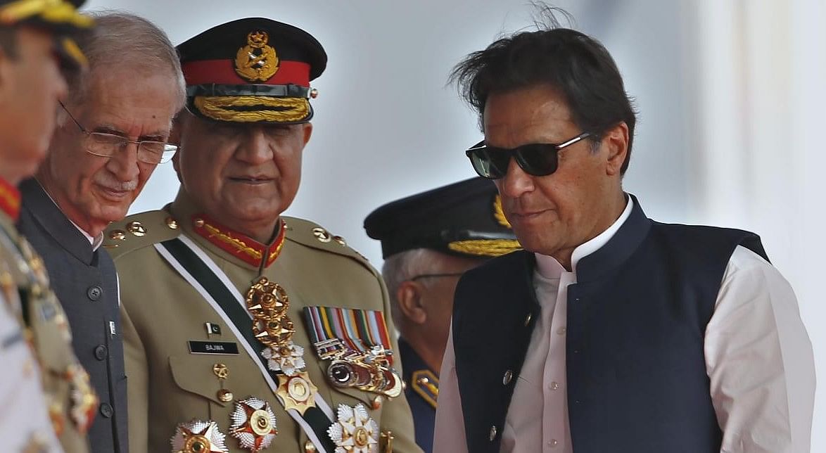 Pakistan's Prime Minister Imran Khan, right, Army Chief General Qamar Javed Bajwa, center, and Defense Minister Pervez Khattaq. Credit: AP