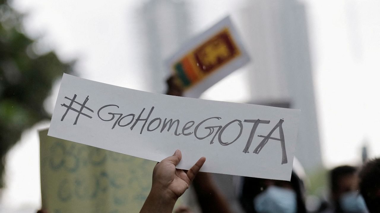  A person holds a placard demanding Sri Lanka's President Rajapaksa to resign during a protest in Colombo. Credit: Reuters Photo