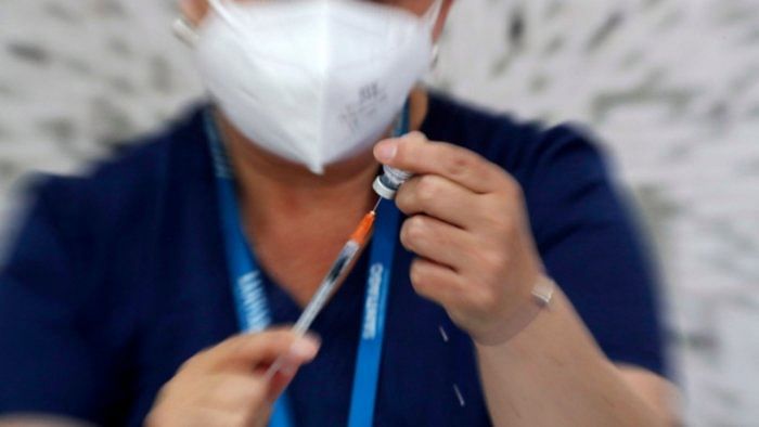 A health worker prepares a dose of the Pfizer-BioNTech vaccine against Covid-19. Credit: Reuters Photo