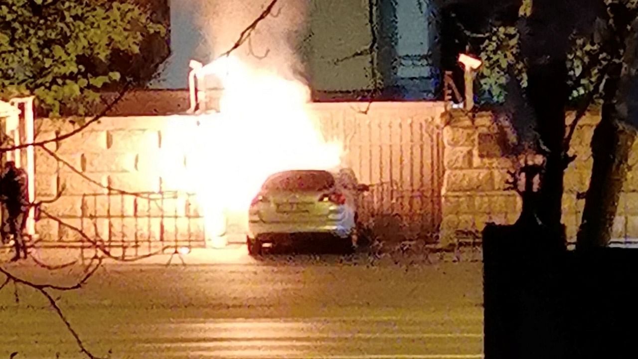 A car that crashed into the gate of the Russian Embassy is seen burning in Bucharest, Romania April 6, 2022, in this screengrab from a video. Credit: Reuters photo