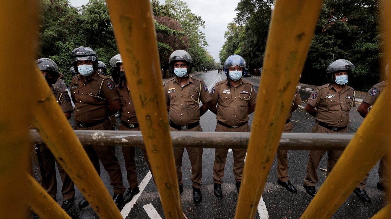 Sri Lanka police officers stand guard on a road leading to the parliament building in Colombo. Credit: Reuters file photo