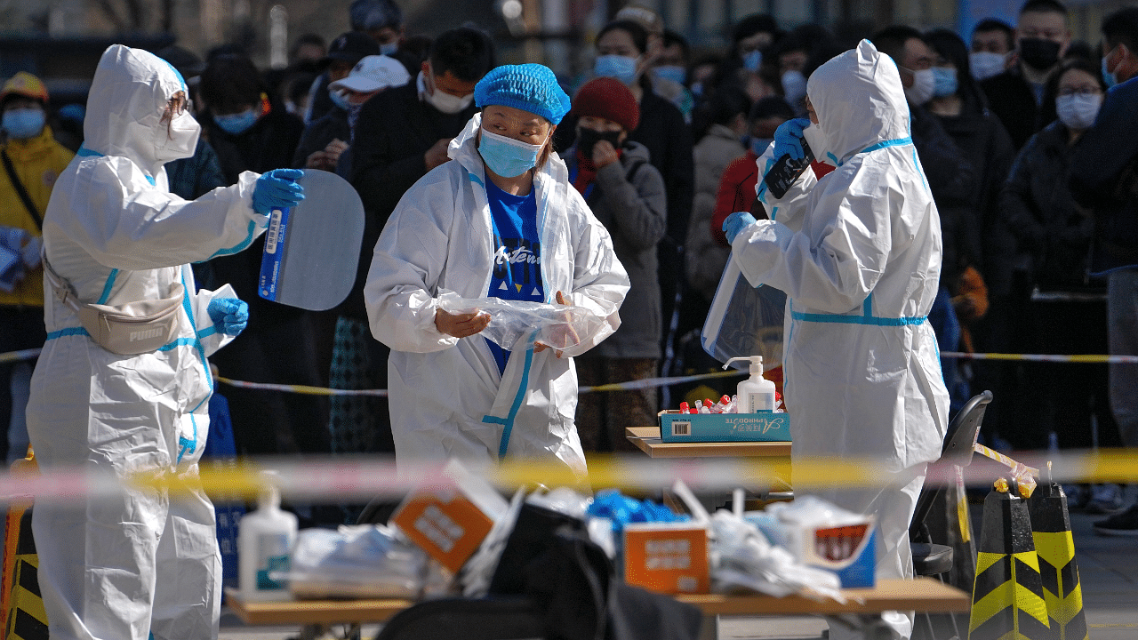 Health workers in protective suits prepare for coronavirus. Credit: Reuters Photo