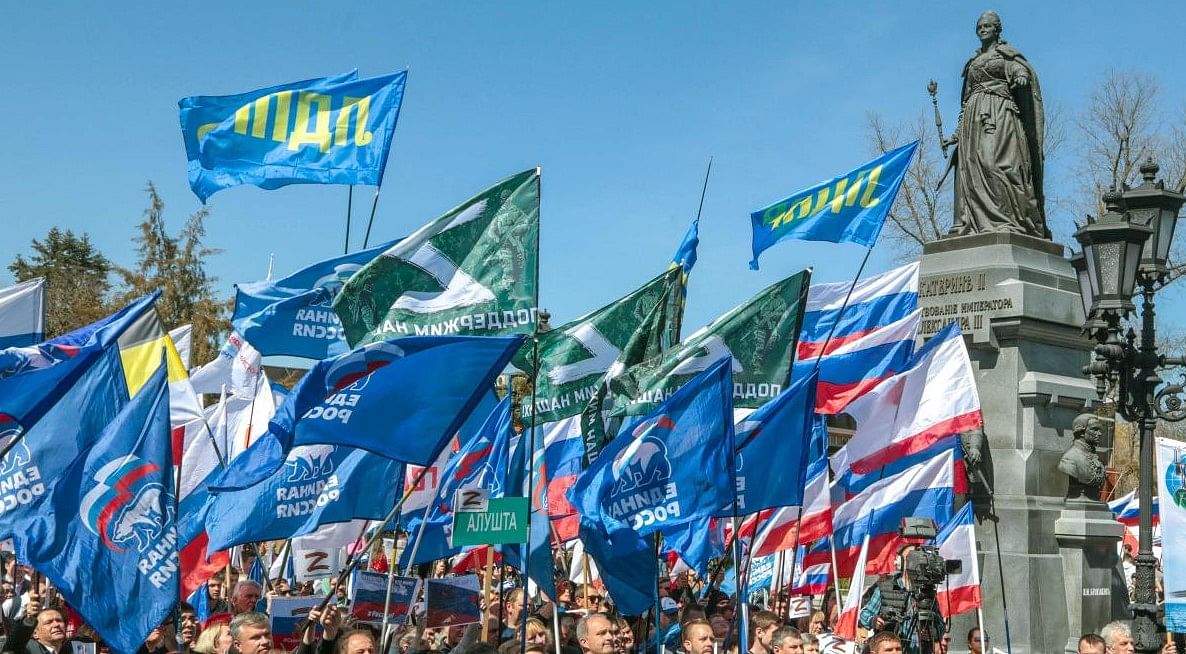 People wave flags during a rally in support of the Russian military operation in Ukraine, in Simferopol, Crimea. Credit: AFP