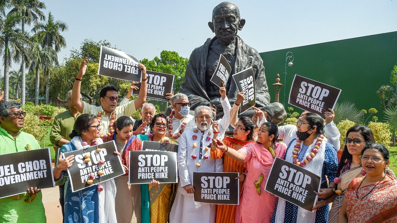 TMC members hold placards during a protest against inflation and fuel price hike, at Parliament House complex, in New Delhi. Credit: PTI Photo