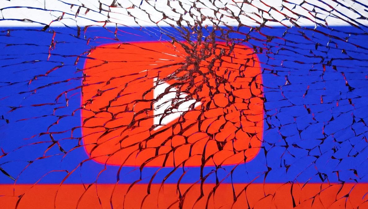 Illustration shows Youtube logo and Russian flag through broken glass. Credit: REUTERS FILE PHOTO