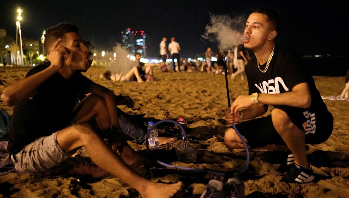 People enjoy the beach at night in the Barceloneta neighbourhood. Credit: REUTERS FILE PHOTO