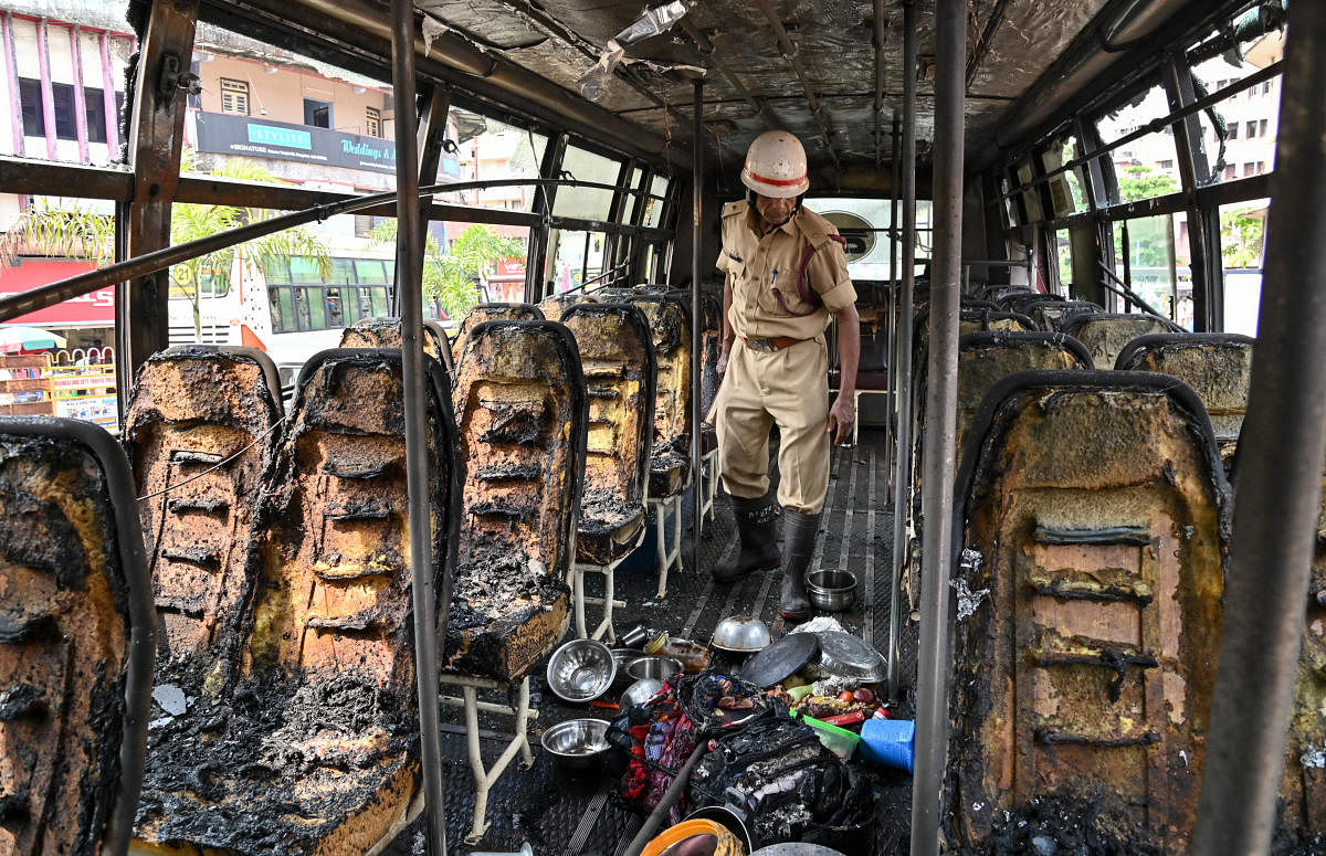 The burnt seats and scattered belongings of the passengers inside the bus. DH Photo