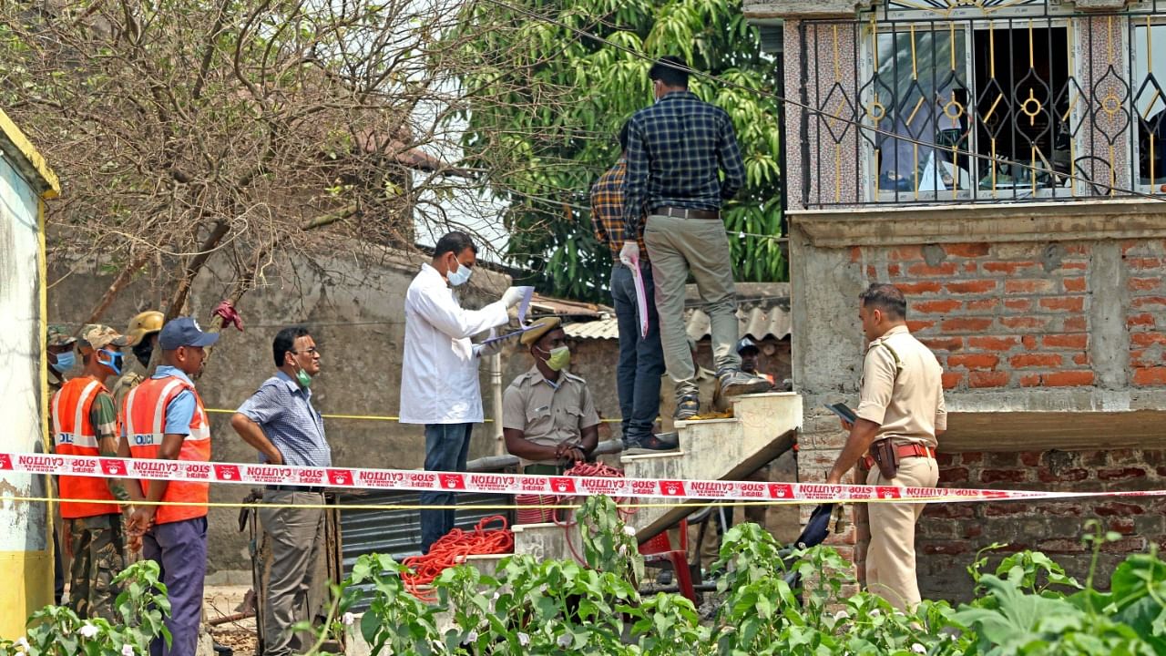 Forensic experts collect samples from the scene of the crime in Birbhum. Credit: PTI Photo