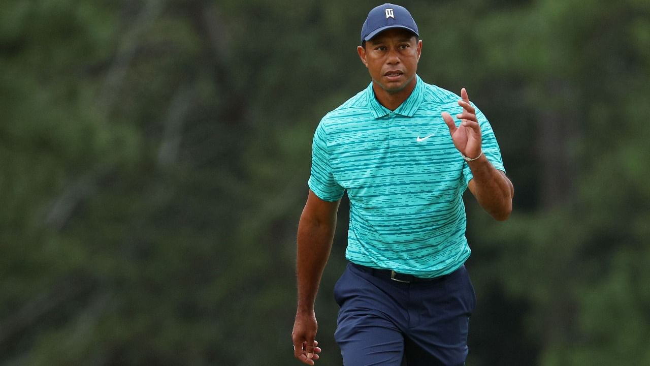 Tiger Woods waves to the crowd as he walks to the 18th green during the second round of The Masters at Augusta National Golf Club. Credit: AFP Photo