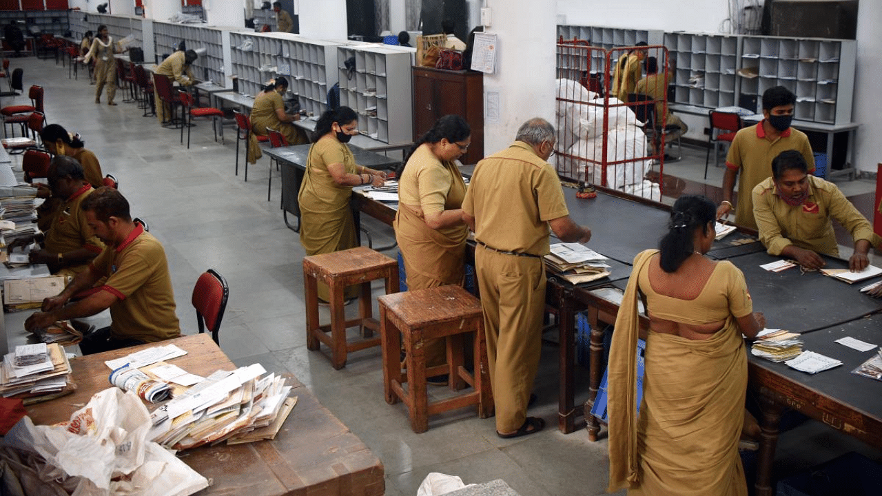 Employees of the General Post Office, Raj Bhavan Road, sort documents for disptach. Credit DH Photo