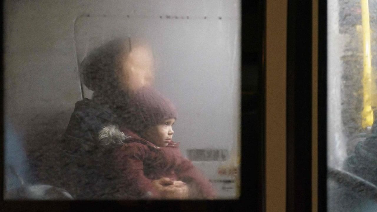 People sit in a bus as an evacuation convoy of buses and cars arrives at a displaced persons' hub in Zaporizhzhia. Credit: AFP Photo