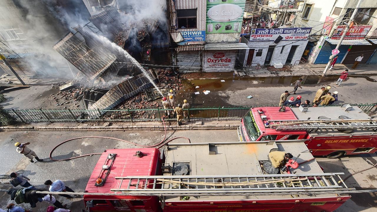 Firefighters try to douse a fire which broke out in Azad Market area, in New Delhi. Credit: PTI Photo