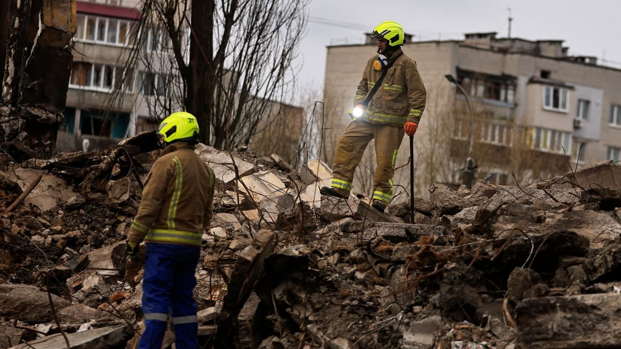 A rescuer holds a torch light to be used to search for bodies under the rubble of a building destroyed by Russian shelling, in Borodyanka, Kyiv region. Credit: Reuters Photo