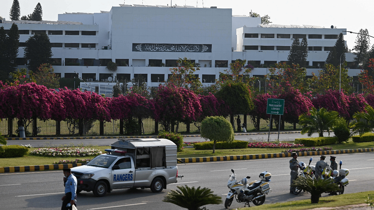 Security personnel patrol outside the Parliament House building in Islamabad. Credit: AFP Photo