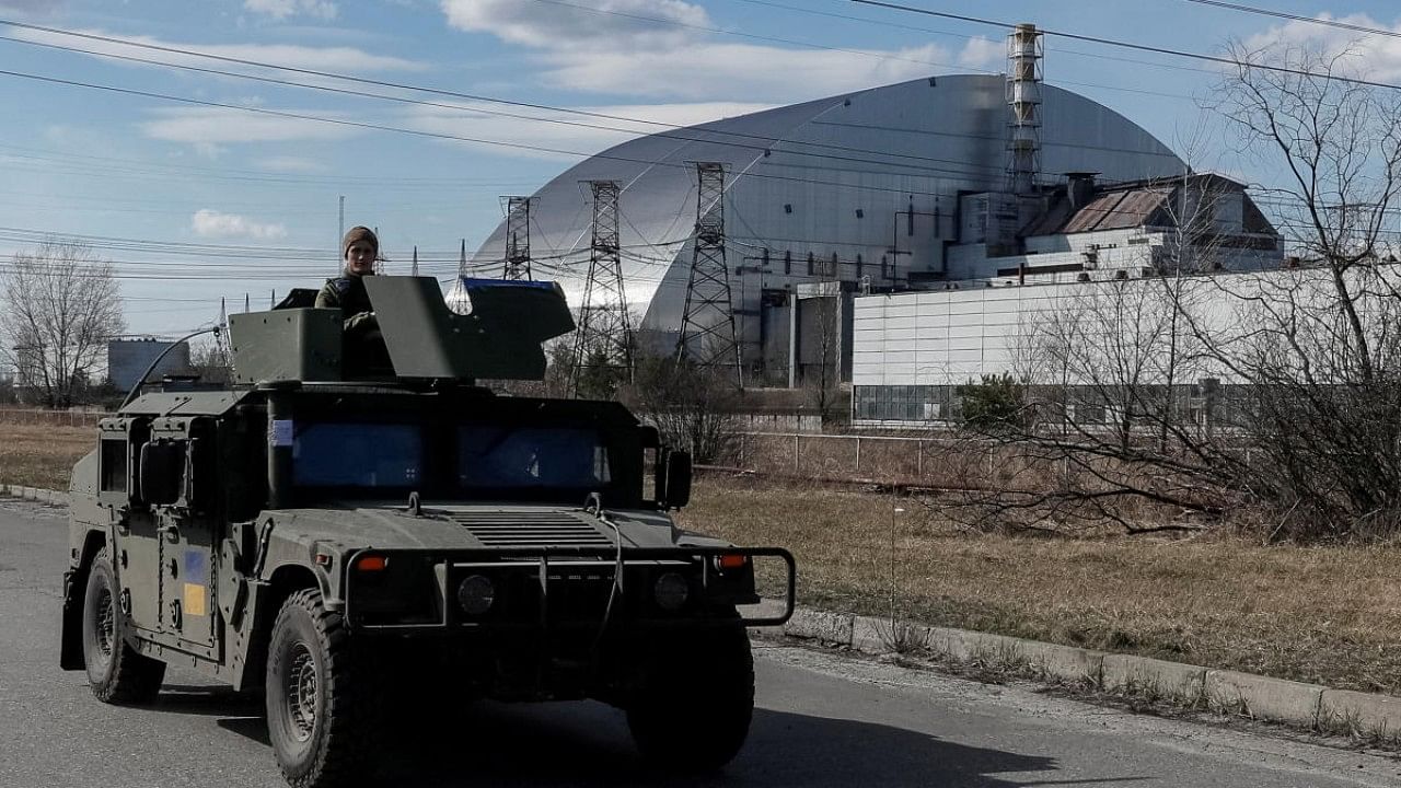 Servicemen of Ukrainian National Guard patrol area near the Chernobyl Nuclear Power Plant, in Chernobyl. Credit: Reuters Photo