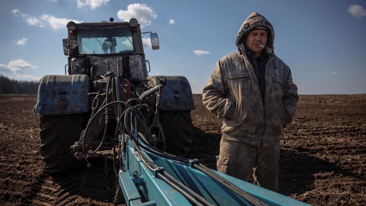 Local farm worker Vladimir takes a break from ploughing a field near the village of Yakovlivka after it was hit by an aerial bombardment outside Kharkiv. Credit: Reuters Photo