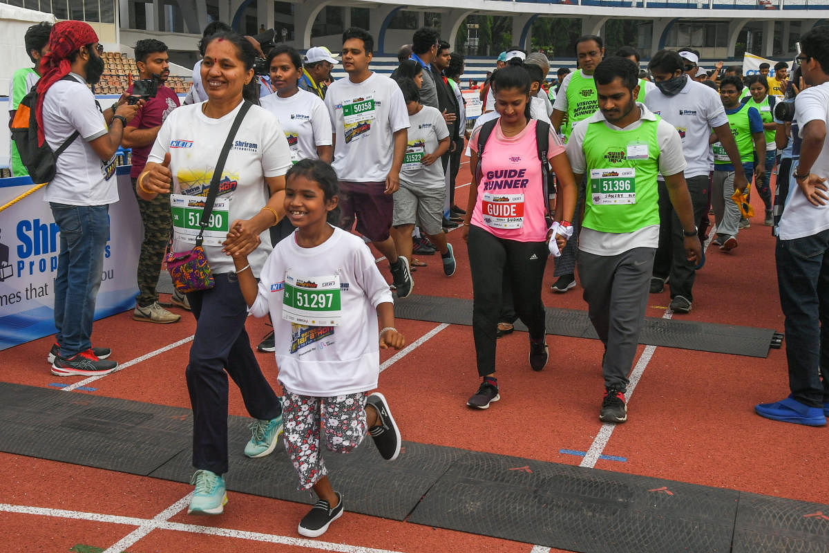 Specially abled, along with their guide runners, take part in the Bengaluru Marathon on Sunday. Credit: DH Photo