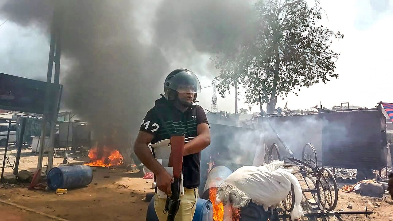 A policeman at the site after a communal clash during the Ram Navami procession, in Himmatnagar. Credit: PTI Photo