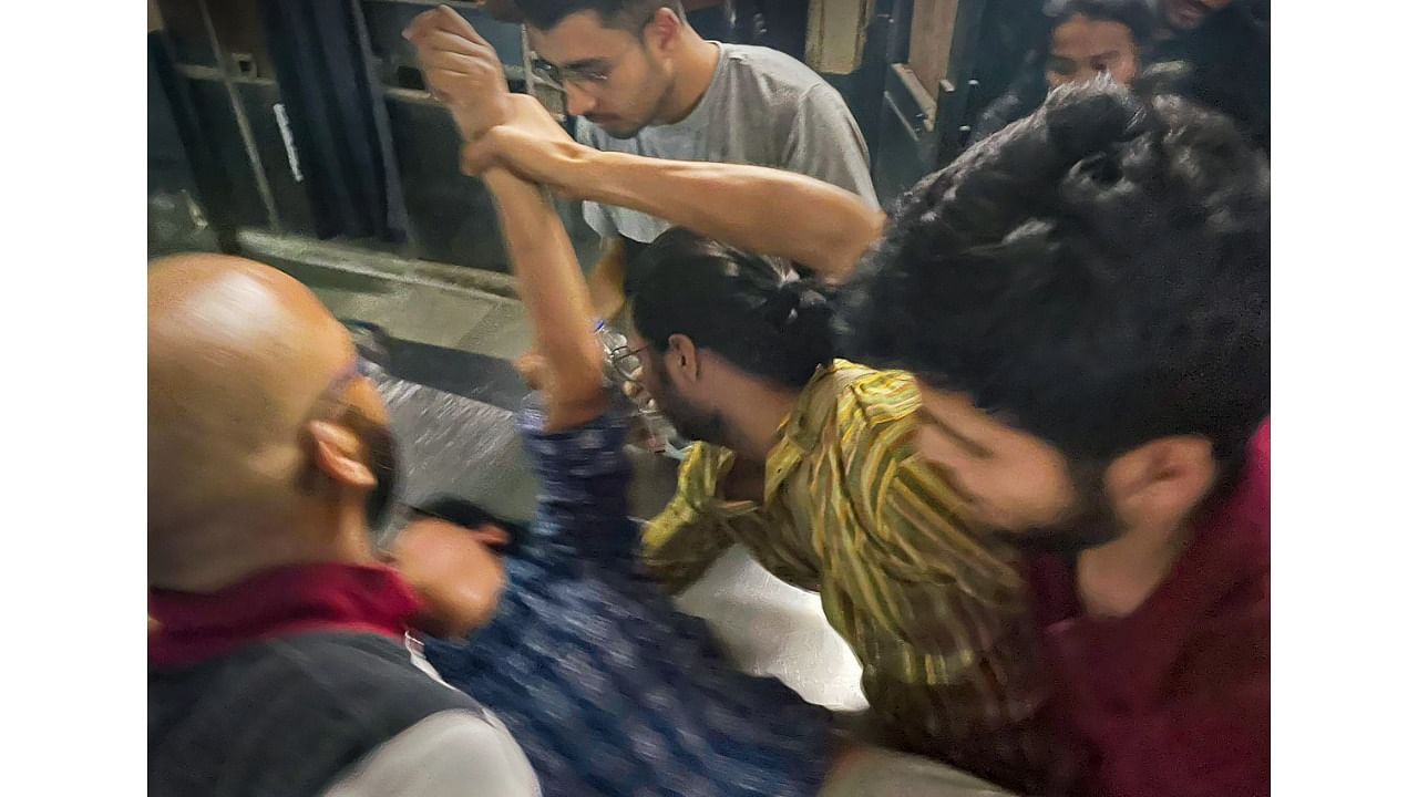 Students tend to a peer who was hurt in the clash. Credit: PTI Photo