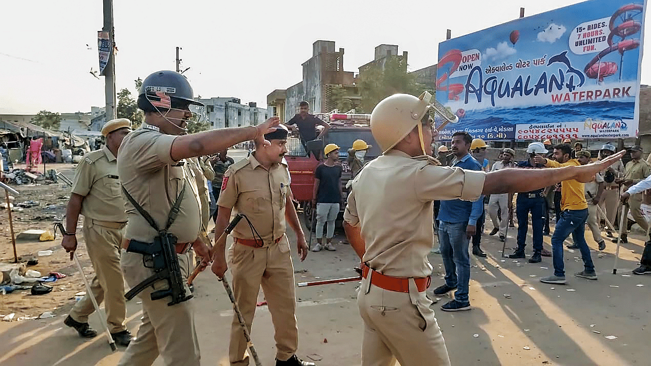 Police try to control the situation after a communal clash. Credit: PTI Photo