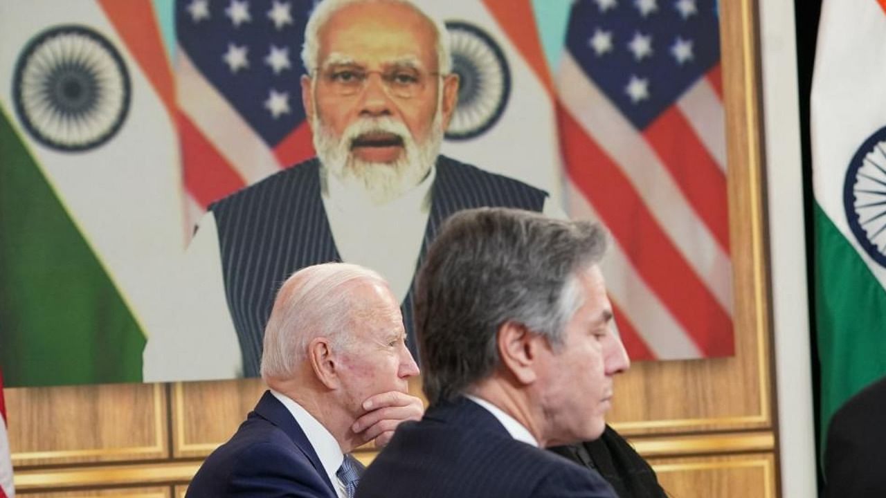 US President Joe Biden (L) and US Secretary of State Antony Blinken (R), take part in a virtual meeting with India's Prime Minister Narendra Modi in the South Court Auditorium of the Eisenhower Executive Office Building, next to the White House, in Washington, DC, on April 11, 2022. Credit: AFP Photo
