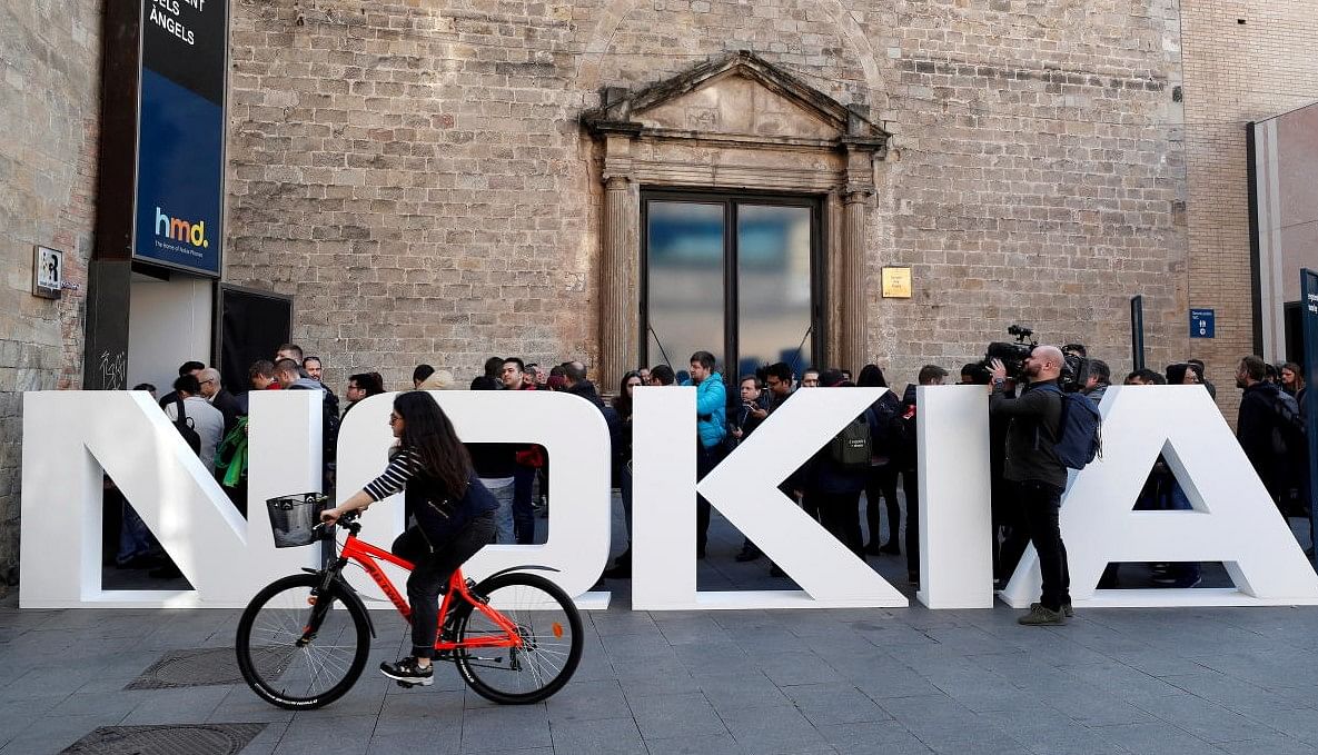 FILE PHOTO: A cyclist rides past a Nokia logo FILE PHOTO: A cyclist rides past a Nokia logo during the Mobile World Congress in Barcelona. Credit: REUTERS