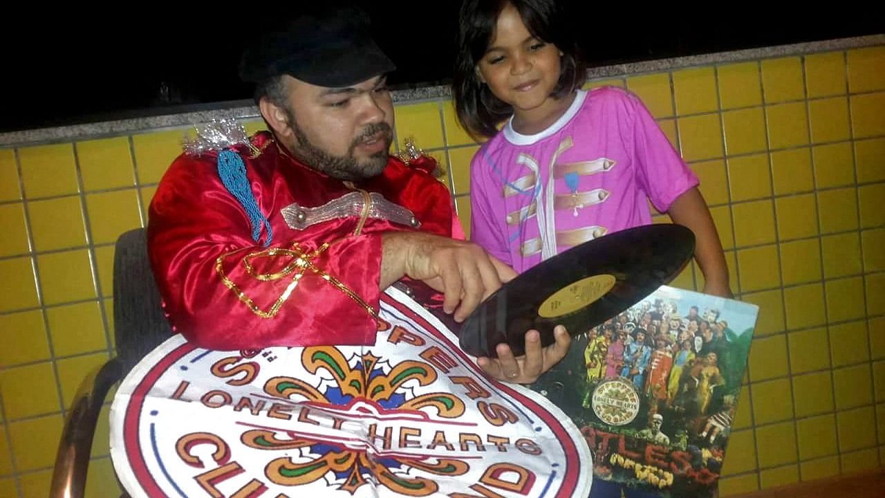 Undated handout picture released by the Schneider family on April 1, 2022 showing Karlo Schneider holding a beattles record next to his daughter Barbara Schneider (R), in Caico, Rio Grande do Norte state, Brazil. Credit: HO/Schneider family/AFP