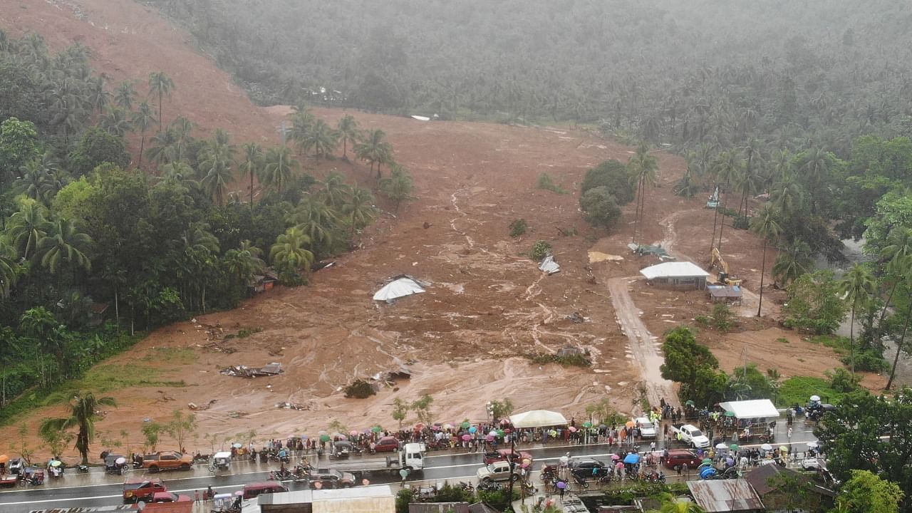 This aerial photo shows the collapsed mountain side and buried houses in the village of Bunga, Baybay town, Leyte province, in southern Philippines on April 12, 2022, a day after a landslide slammed into the village due to heavy rains brought about by tropical storm Megi. Credit: AFP Photo