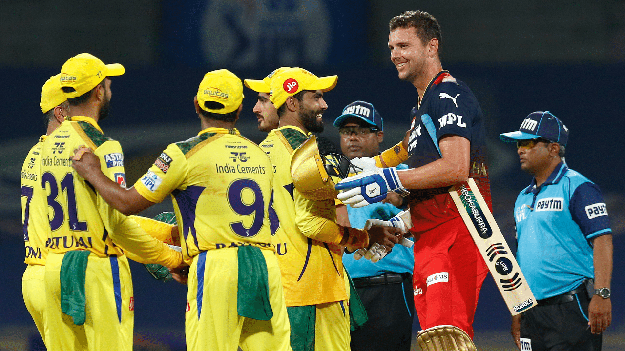 Players greet each other after the Indian Premier League 2022 cricket match between Chennai Super Kings and the Royal Challengers Bangalore. Credit: PTI Photo