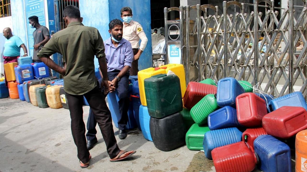 People wait in a queue to buy diesel at a Ceylon Petroleum Corporation fuel station in Colombo. Credit: AFP Photo