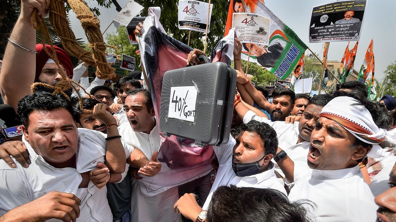  Indian Youth Congress President Srinivas BV with members raise slogans during a protest outside Union Home Minister Amit Shah's residence demanding the resignation and arrest of Karnataka Minister KS Eshwarappa, over the death of contractor Santosh Patil. Credit: PTI Photo