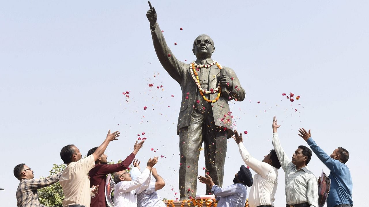 Members of All India PSB SC/ST Employees Welfare Council, pay tribute to a statue of social reformer B. R. Ambedkar on the occasion of his birth anniversary, in Amritsar. Credit: AFP Photo