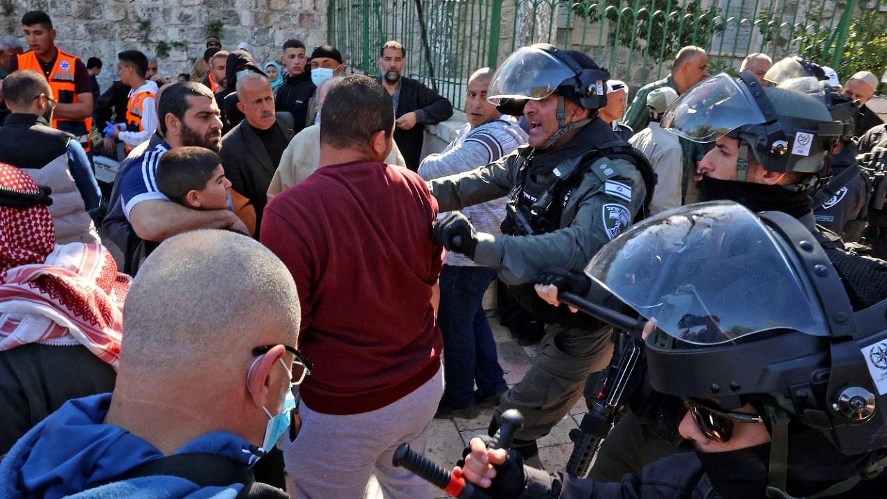 Israeli security forces scaffle with Palestinian men as they try to enter the Al-Aqsa mosque compound. Credit: AFP Photo