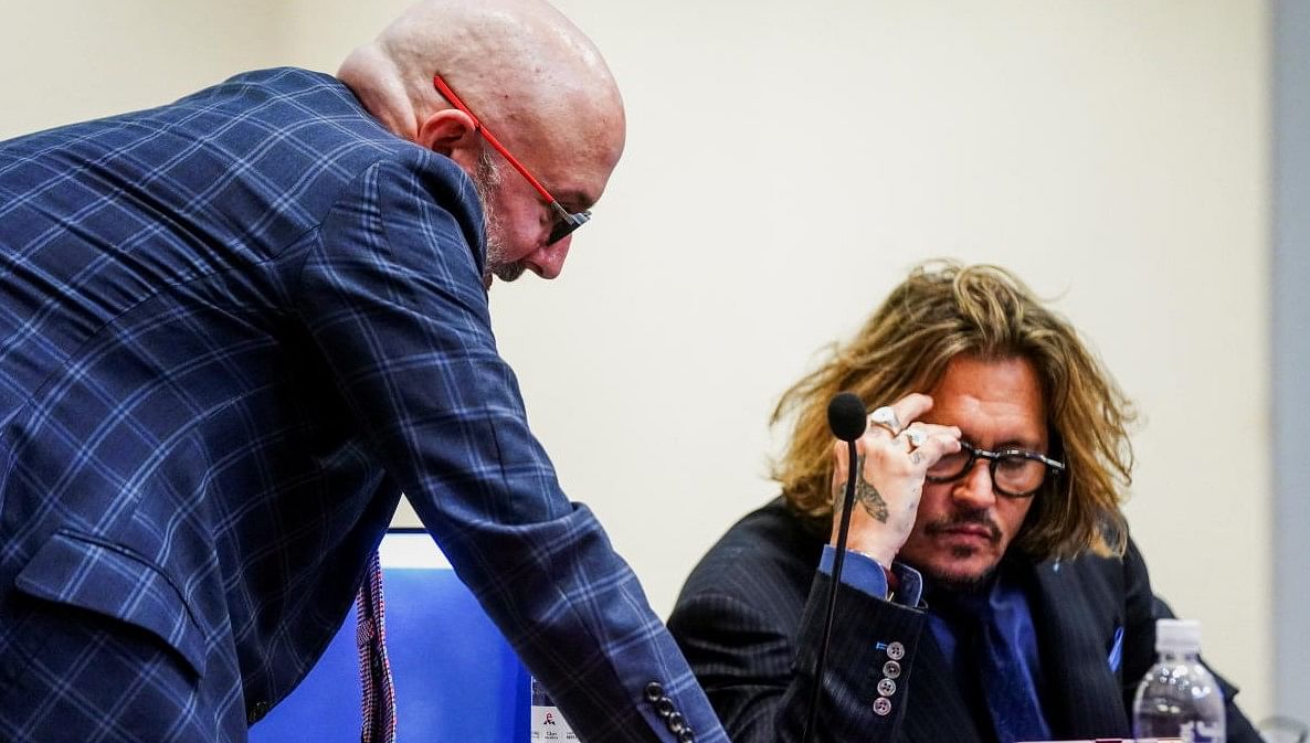 Actor Johnny Depp confers with an attorney during his defamation case against ex-wife Amber Heard at the Fairfax County Circuit Court in Fairfax, Virginia, U.S. Credit: Reuters