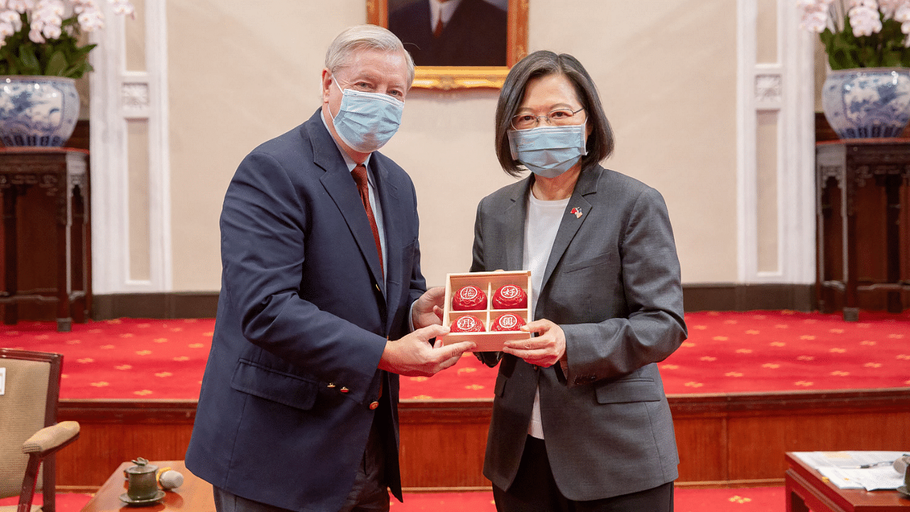 US Senator Lindsey Hraham (L) receiving a gift from Taiwan President Tsai Ing-wen. Credit: AFP Photo