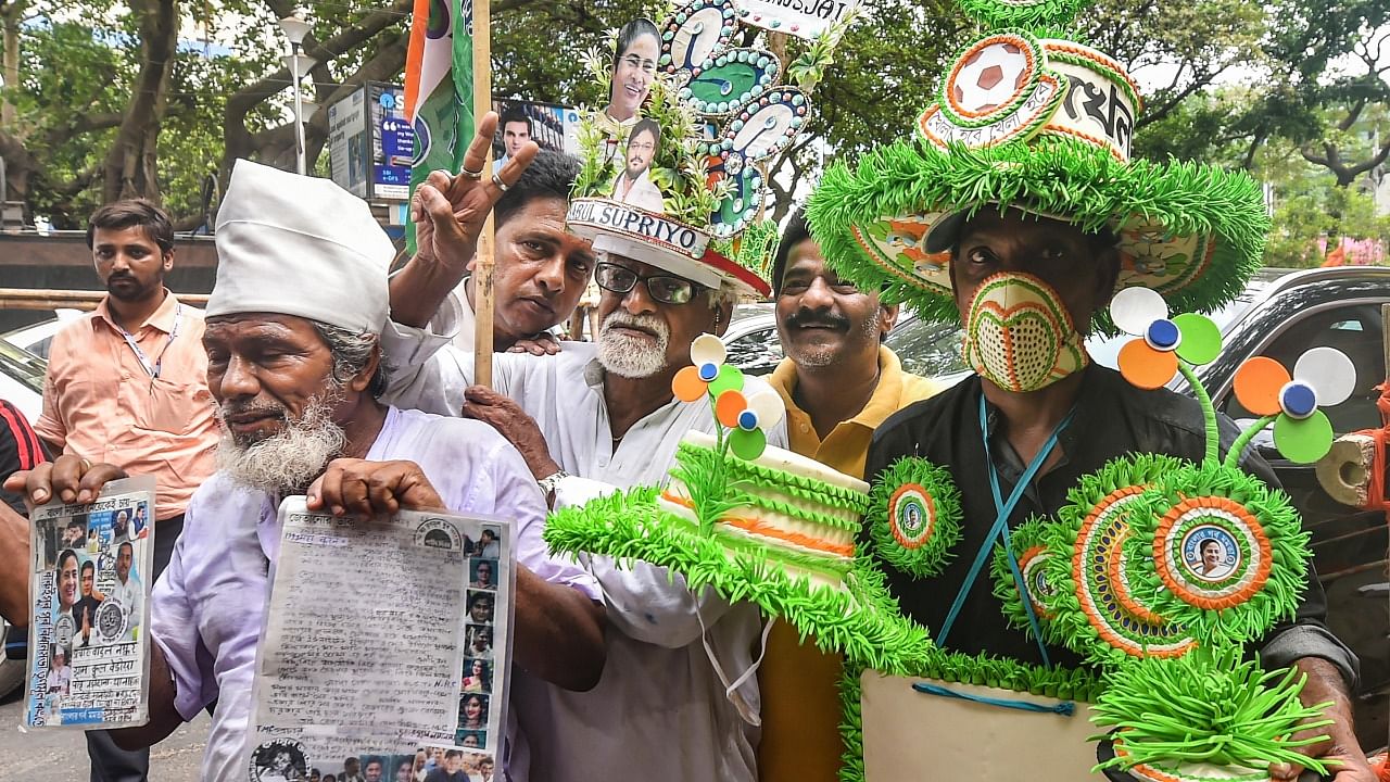 TMC supporters celebrate after their candidate Babul Supriyo won Ballygunge Assembly bypolls in Kolkata. Credit: PTI Photo